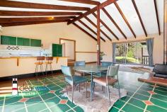 148 Ridge Rd Central Tilba NSW 2546 $690,000 "Kennocha" - Not far from Central Tilba and a short drive to Mystery Bay with its many pristine beaches, is this lovely home set on approximately 7 acres. Relax, sit on the covered veranda and enjoy the surrounding bushland with an amazing amount of birdlife and animals. The Home: High ceilings with hardwood beams, timber floors, open plan living, dining and kitchen. Lots of large windows and doors leading onto the wrap around veranda. Three good sized bedrooms, central bathroom, separate toilet and spacious laundry are located at the rear of the home. Access is via steps at the front, near level entry at the rear or a ramp leading onto the side veranda for those who cant handle stairs. Power is connected to the home plus there is solar hot water and eight panels to lessen your electricity account. Water storage, approximately 90,000 litres. Acreage: 2.67 hectares approximately with some fencing. There is an established orchard, macadamia, olive, and many other fruit trees. From Ridge Road, there is a gently sloping driveway leading up to the home, shed, caravan and the carport. Caravan: Ideal for extra visitor accommodation when those unexpected guests turn up to enjoy your rural piece of paradise. A carport has been built over the caravan for protection and comfort in the warmer summer months. Rustic Workshop: Art Space, Man/Woman Cave, Games Room, Workshop, Craft Room etc. Make this space what you want it to be. Location: Located close to Corunna Lake, not far from Central Tilba and a short drive to Mystery Bay, Narooma or Bermagui.