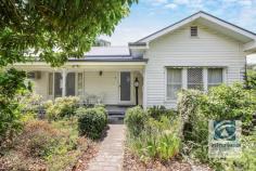 2 Tower Street Wodonga VIC 3690 Located only minutes away from the fast-developing CBD lies this family home filled with character and charm. Upon entering through the established front garden, you are greeted by the gorgeous weatherboard home creating a private oasis sure to leave you in awe. Ornate cornices, ceiling roses and chandelier light fittings encompass the stunning period features that bring this home to life. Comprising of three generous bedrooms, two of which include built in storage. The family bathroom is conveniently located central to the bedrooms and features a deep bath, single vanity and toilet. An additional shower and toilet can be found in the laundry providing added flexibility for the growing family. With a naturally flowing floorplan, the spacious front lounge transitions through to the formal dining room with sunroom adjacent. The kitchen is where style meets character, comprising of an impressive curved bench with electric appliances and spacious walk in pantry. Ducted heating & evaporative cooling provide comfort all year. Outside the undercover entertaining area, perfect for year-round gatherings overlooks the low maintenance rear yard. With established plants lining the fence your family can enjoy a picturesque setting. The single garage accessed from a secure driveway will keep the family vehicle safe and provide enough space for a workbench and all the tools to be stored. Only a stones throw away from the centre of town your weekends and date nights will never be the same. Call today to secure your very own private central sanctuary!