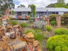 91 Denny Road Nannup WA 6275 $645,000 If you love character in a home then there is no doubt you will fall wildly in love with this one! A decade of work results in a spectacular creation from the unusual gate, the wysteria trellis, the rocky waterfall, the rusty bits of iron in the garden and timbers from both the Busselton and Bunbury jetties in the house. Sitting on a lovely 6.6 acres with Blackwood National Park to the front and the Blackwood River at the back this three bedroom, two bathroom home with its brick hearth and huge jetty beams breathes character from every pore! The mostly native gardens are easy to keep and stunningly attractive. The large back deck looks onto a waterfall with a pond at the base and views of the distant hills. Large shed, fenced orchard and vegie garden, not to mention a fox proof chook pen plus a second smaller waterfall complete the picture. Large dam at the bottom of the block supplies water for the garden and waterfalls with power in 3 places plus gorgeous riverfront views down at the bottom of the block. This has to be seen to be appreciated.