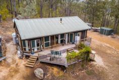 49 Blaxlands Arm Road Laguna NSW 2325 $420,000 to $440,000 – A secluded timber cottage awaits the new owner in the picturesque Wollombi Valley – Rare 5 acre lot in a natural bush land setting, set into the hill with views through the trees towards the surrounding mountains – Inside, cathedral like ceilings adorn the whole of the internal cottage creating a wonderful ambiance – The timber kitchen is open planned and looks out over the living and dining space, timber flooring throughout add to the feel of the cottage – A brand new split system A/C and combustion fireplace make this a comfortable home all year round – The two bedrooms are to one end of the cottage and are quite sizeable, with bush views – The bathroom is combined with the laundry and has a claw foot bath and corrugated iron feature walls – Opening from the living room is the large timber deck overlooking the duck pond, the perfect place to relax, enjoy a BBQ and entertain – Tank water is supplied by an approx 20,000 litre tank and a garden shed for storage complete the package – Mains power, very rare in this location! – A new lifestyle awaits, or the perfect opportunity for a weekender to escape the city life. Call to arrange your inspection today!..