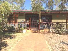 5 Noble Street Tennant Creek NT 0860 $250,000 The Territory is a great place to enjoy the great outdoors and this home has been established to capitalize on that. Located on the highly sort after Western side of town, this 4 bedroom, 2 bathroom residence is ready for new owners. Enter directly into the air conditioned, large open plan lounge/kitchen/dining area, with 2 of the bedrooms directly accessed from this area. From the kitchen a hallway runs the length of the house and gives access to the family bathroom, the 3rd bedroom, a second lounge area and the large master bedroom complete with walk in robe and ensuite. All bedrooms have air conditioning and fans and there are data points throughout the home. Outside the wrap around verandah is a perfect place to relax after work while supervising the children in the fully compliant inground swimming pool. This home set on 872m2 with rear lane access, is a reluctant sale. Currently leased for $350 per week.
