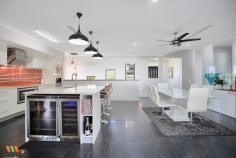 20 Eyre Pl Erakala QLD 4740 $1,100,000 This exquisite property built in 2014, satisfies the wishes of the most discerning buyers with a stunning floorplan that boasts 382sqm of underroof perfection. The house is efficiently located on a 2000sqm block with so much room available for additional shed (12mx8m plans available on request), driveways, tennis courts, or anything your imagination desires. Two driveway crossovers are at your disposal with the elevation of the block providing stunning views, constant breezes & the opportunity for striking tiered presentation. Many builders were consulted to design the home adopting the natural slope of the land & the final result is exceptional, allowing the inground pool & surrounding entertaining area to be integrated into the second level of the home, providing stunning views from all bedrooms that overlook. Leading from the double remote panel lift garage door via cascading polished timber stairs, the second level of the home immediately introduces the open plan kitchen, lounge & dining rooms that flow seamlessly via stacker screens to the outdoor entertaining area & pool. The formal lounge room has vistas as far as the Pioneer Valley & mountain lines thanks to the elevation provided at the very back of Settler's Rise Estate. The dining room is overlooked by the Caesar stone-top island bench, complete with breakfast bench, DeLonghi appliances, induction cooktop, double sink, integrated wine & beer fridges & a Butler's Pantry that the most established of chefs would die for! In fact, the Butler's Pantry possesses the best views of the home with the glassed louvres acting as a beautiful outlook, complete with space for appliances, fridges & ample storage. Leading from the kitchen, take a few steps up to the formal lounge which continues the open plan theme with stylish cut-outs that define the space & is adjacent to the handy double-desked office nook that also leads to outside. Leading from the hall, are 3 generously sized, built-in, air conditioned, carpeted bedrooms, plus a 3rd living area or devoted media room that is fully enclosed offering cozy privacy & seclusion. The bathroom & laundry has been thoughtfully designed, allowing wet feet from the pool entry via the tiled laundry & immediately into the luxuriously appointed bathroom. A separate toilet with powder room also caters for guests. At the end of the hall, a stunning introduction to the Master Suite is the glassed entry overlooking a lush fernery where the outside gardens are almost invited inside, adding to the extravagance that is afforded firstly in the Parent's Sitting Room with TV connection, then the enormous open plan ensuite & finally the king sized bedroom & massive walk in robe that acts as a separate dressing room. The Parent's Wing absorbs the furthest end of the property, has its own private deck overlooking the pool & provides all the privacy required to escape the world! Downstairs provides double car accommodation plus a generously sized storage room that has been reinforced with core filled walls to act as a cyclone shelter, providing families with even further peace-of-mind that the attention to detail adopted in the creation of this property is second to none! The 2000sqm block is enormous & due to the forethought when designing, the house has been nestled into the back right corner, allowing new owners the freedom to develop the remainder of the block in whichever way they choose, stamping it with their own style & vision!