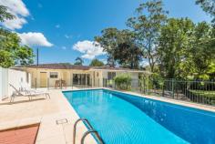 38 Chamberlain Road Wyoming NSW 2250 Sitting on just over 1 acre of parklike grounds with perfect north-east aspect and overlooking a freshwater creek meandering through shaded landscaped grounds, is this superbly renovated large 3-bedroom, single level home. The sophistication and high quality of the renovations reflects the owners’ North American inspired design, decorative skills and fine tastes. The property offers separate front and rear gated entrances, a double garage and expansive private enclosed courtyard and pool complex. Facing north is an enormous covered terrace perfect for outdoor entertaining. There is an additional backyard area with established fruit trees and raised garden beds. The immediate impression upon stepping into the house is of a grand open plan living space featuring beautiful tiled flooring throughout, a superbly arranged and incredibly functional kitchen with an oversized island and stone waterfall countertops. The bedrooms are substantially oversized with walk-in closets and are presented to the highest of standards. Both the main and ensuite bathrooms are fully renovated and reflect unique design cues from the US. There is an additional half bathroom for the pool area along with an outdoor hot and cold shower. – Stunning level small acreage on meandering stream – Unique floor and wall tiling throughout compliment the high level of restoration – New kitchen appliances – Zoned, Ducted reverse air conditioning – Large, North facing covered entertaining terrace – In-ground saltwater concrete pool – Rainwater tanks – Minutes from shops and Gosford train station – Potential for further development due to land size and dual-access, STCA…