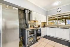 12 Railway Parade Tallong NSW 2579 $549,000 DUE TO COVID-19 RESTRICTIONS ALL INSPECTIONS ARE BY APPOINTMENT ONLY Set in an elevated location offering distant bush views and great proximity to the village shop, school and station. The solid brick home offers a generous mud room to entry foyer and open plan living with large windows for light and to maximise your views over the garden and abundant birdlife. The newly renovated kitchen is the hub of the home and services the living/dining space seamlessly. Pressed metal splash back, wood fire stove + free standing gas cooktop/oven The home offers 9 foot ceilings, split a/c + gas points + Hydronic heating Plenty of water storage totalling close to 100,000 litres + septic for waste Solar + battery backup, dual wired, enabling usage in blackouts and use of batteries instead of mains power within the home Master suite is generous in size with large walk through robe and ensuite Remaining 2 bedrooms also sizeable and serviced by a family bathroom + internal laundry Under home offers workshop + double tandem carport, there is a free standing single garage with carport + various outbuildings for storage and entertaining gazebo The rear deck offers added entertaining space and looks over the yard and selection of fruit trees beyond including berries, cherries, apricots, quince etc. Optional extras include the block being on two titles with the ability to sub-divide or just enjoy the space from neighbouring properties. Fencing is in place and the grounds are low maintenance. Call today to book your private viewing….