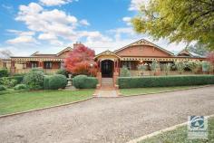 173 Edmondson Lane Wooragee VIC 3747 $995,000 Resting on five established acres, this master craftsman built home has been constructed with only the best materials sourced from all over Australia. With such a magnificent property like "Fernleigh", it's difficult to know exactly where to begin. This Edwardian style home, built in 2002, features traditional finishes such as red brick exterior, cedar timber framed windows with decorative leadlight, gabled roof with timber finials, 10 foot ceilings, tessellated tiles in the bathrooms and laundry, decorative paved entry path plus wide verandas on three sides with embellished timber fretwork. The entrance is nothing short of impressive and leads you to the lounge room with formal dining and impressive fireplace and overmantle, or through to the family room with adjoining kitchen and conservatory. Can you imagine enjoying your breakfast in the morning sunlight? The country style kitchen, complete with Kauri pine flooring, features timber cabinetry and red brick chimney with an ever efficient Thermalux slow combustion stove. The master suite is captivating. With king-size walk-in robe, ensuite, bay windows and two sets of French doors. Bedrooms two, three and four all have large built in robes and French doors leading directly to the veranda. Additional features include a double lock up garage with direct internal access, a 14m x 9m workshop/shed with toilet and shower, a 65,000 litre concrete tank and 22,500 litre poly tank, reliable well and a large dam. A beautiful garden, with the perfect blend of deciduous and evergreen plants, ensures year round colour has been thoughtfully designed for you to enjoy. Your new country lifestyle is approximately 12 minutes from Beechworth and Yackandandah and an easy 25 minute drive to Wodonga. There is simply too much to mention and only your private inspection will reveal all this amazing property has to offer.
