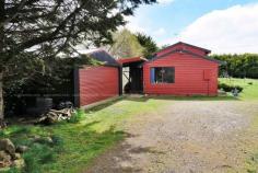 828 Cradle Mountain Road Erriba TAS 7310 $265,000 Set on 4,047 square metres, in the highlands of Erriba, this is a very neat two storey, two bedroom timber cottage with room for a few cottage industry domestic animals and free range poultry. Room to garden and nurture fresh produce for the table while enjoying the climate and rural views that the area provides. The home is clad in stained timbers, it features one up one down bedrooms, a bright and well appointed kitchen with breakfast bar and adjoining dining area, comfortable living room with sliding door access to an undercover verandah area. The interior also features natural timbers throughout. A double garage with remote access provides secure parking, with ample storage and utility shed areas adjoining and providing laundry. The title is securely fenced for children and pets. The gardens feature a mix of ornamental and native plants. The home is bright and provides for scenic views of the surrounding countryside. During the colder winter months enjoy the option of a glowing wood heater, or the convenience of electric heat on thermostat and timer. Domestic water is supplied from a 5,600 gallon water tank collecting rain waters from the house and shed roofs in what is a very reliable rainfall area of approximately 1250 to 1400mm per year. This is an ideal location to commute for work in surrounding rural areas, or to the hospitality and tourism of the Cradle Mountain areas. Many people choose the surrounding areas for commuting in and out for shift working and return for the privacy and down time afforded by the location. Approximately 40 to 45 minutes travelling time to Devonport, Latrobe or Ulverstone, 30 minutes to Sheffield or Cradle Mountain and 10 minutes to Wilmot – it is only a short and very pleasant drive to all surrounding regional centres. Currently tenanted, an inspection will require appropriate advance notice.