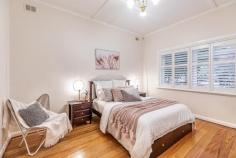 5 Gertrude Street Glandore SA 5037 $795,000 to $855,000 Proudly positioned on Gertrude Street among other beautiful character homes, this 1944-built stone-fronted stunner is set to steal your heart. Set behind an elegant front garden of mature trees and bursting roses, a wonderful family opportunity awaits here. From the tiled formal entry, a stunning feature gas cast iron fireplace in the formal lounge will instantly catch your eye. Making your dinner guests feel just as at home as you are, you will relish good company in a most cosy adjoining dining room with French doors onto the side carport. Lined with pine floors and ornate 3m ceilings, the front half of the home is where you will also find the luxurious master bedroom with walk-in robe and ensuite. Enjoying a beautiful front garden outlook, parents are sure to appreciate its distance from the three remaining bedrooms. Cooks of the house will thrive in the white U-shaped kitchen with wraparound breakfast bar, gas cooking, dishwasher and a wealth of storage space. A superb rear extension houses an enormous family area and main bathroom with bath, dual vanities and European laundry, servicing three further bedrooms (or two + home office/study) which all offer the convenience of built-in robes. Full-height picture windows and more Colonial-style French doors take advantage of the natural light on offer courtesy of a north-facing backyard, where an extensive paved alfresco is perfectly protected by a gabled pergola with ziptrack weather-proof blinds. Bordered on each side by private hedging and a slatted timber wall, you’ll never tire – and neither will the kids – of your beautiful backyard, where a playable-sized lawn area extends to a cubby house, sand pit, raised garden beds and established greenery, including an apple, pear and feature fig tree providing a shady spot as well as a bountiful summer crop. Delight in the details: – 3KW Solar system – Ducted zoned reverse cycle air conditioning throughout – Full-height tiling to bathrooms – 697sqm block (approx.) – Extensive front & rear irrigation with grey water from laundry – Huge side carport with auto roller door + off-street parking – Rear tool shed In case you aren’t familiar with the location, a two-minute stroll from here will lead you to the Glandore Oval & Playground, Black Forest Shopping Centre or Primary School and bus, train or tram to City, sea or in between. It’s all here and it can all be yours. A true Glandore beauty.