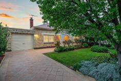 5 Gertrude Street Glandore SA 5037 $795,000 to $855,000 Proudly positioned on Gertrude Street among other beautiful character homes, this 1944-built stone-fronted stunner is set to steal your heart. Set behind an elegant front garden of mature trees and bursting roses, a wonderful family opportunity awaits here. From the tiled formal entry, a stunning feature gas cast iron fireplace in the formal lounge will instantly catch your eye. Making your dinner guests feel just as at home as you are, you will relish good company in a most cosy adjoining dining room with French doors onto the side carport. Lined with pine floors and ornate 3m ceilings, the front half of the home is where you will also find the luxurious master bedroom with walk-in robe and ensuite. Enjoying a beautiful front garden outlook, parents are sure to appreciate its distance from the three remaining bedrooms. Cooks of the house will thrive in the white U-shaped kitchen with wraparound breakfast bar, gas cooking, dishwasher and a wealth of storage space. A superb rear extension houses an enormous family area and main bathroom with bath, dual vanities and European laundry, servicing three further bedrooms (or two + home office/study) which all offer the convenience of built-in robes. Full-height picture windows and more Colonial-style French doors take advantage of the natural light on offer courtesy of a north-facing backyard, where an extensive paved alfresco is perfectly protected by a gabled pergola with ziptrack weather-proof blinds. Bordered on each side by private hedging and a slatted timber wall, you’ll never tire – and neither will the kids – of your beautiful backyard, where a playable-sized lawn area extends to a cubby house, sand pit, raised garden beds and established greenery, including an apple, pear and feature fig tree providing a shady spot as well as a bountiful summer crop. Delight in the details: – 3KW Solar system – Ducted zoned reverse cycle air conditioning throughout – Full-height tiling to bathrooms – 697sqm block (approx.) – Extensive front & rear irrigation with grey water from laundry – Huge side carport with auto roller door + off-street parking – Rear tool shed In case you aren’t familiar with the location, a two-minute stroll from here will lead you to the Glandore Oval & Playground, Black Forest Shopping Centre or Primary School and bus, train or tram to City, sea or in between. It’s all here and it can all be yours. A true Glandore beauty.