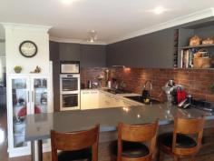 21/45 Leahy Close Narrabundah ACT 2604 $775,000+ This split-level, three bedroom, two bathroom, dual-living area home has been completely renovated - ready for you to move in and enjoy - and offers an easterly outlook with commanding views from Russell/Mt Ainslie over Canberra Airport through to Karabar and Jerrabombera. Double-glazed windows with security screens and plantation shutters offer both security and privacy, whilst the unique design of this home provides bedroom segregation and fully functional, integrated living areas. This larger than average town-house offers comfortable living environs throughout including open-plan formal living areas, a modern kitchen with adjoining family room - both of which enjoy sun-drenched mornings and each of which also extend onto private outdoor terraces. The upstairs living areas also feature full-width plantation shutters to the balcony and a remote-controlled Balinese fan. Floating floors in the entry hall, stairwell, family room, kitchen and upstairs hallway also add style and practicality to these high-traffic areas. The Kitchen has been fully renovated by "Kitchen Co" and features: a double Westinghouse oven; microwave and gas cooktop; a step-in pantry; oversized fridge space; raised breakfast bar; hidden cabinetry; integrated NBN; dimming down-lights; double black sink and ceaser-stone bench-tops and is complemented by soft-close drawers and loads of storage space. A gas ceramic fire-place sits atop a slate and Canberra-Brick hearth with an exposed flue/chimney. Entertainment needs are also covered with the 65" HDD LCD TV with sound-bar system and fully integrated antenna, HDMI and LAN connectivity throughout the home. Year-round comfort is also assured through the split-sytem, integrated aircon and heating. The Laundry and bathroom have also been fully renovated with an oversized HWS installed, built-in linen cupboard and laundry tubs - also fitted by KitchenCo. A frame-less shower-screen and rain shower-head complete the package. The renovated en-suite features built-in towel storage, a free-standing bathtub, frame-less shower-screen, shower panel, niche shaving cabinets and under-tile floor heating. Mirror doors to the built-in robes and a wall-safe add to the overall functionality and exceptional design of this home. Freshly painted throughout, both balconies have also been waterproofed and resealed, plumbed and the lower balcony has been fitted with a 20amp circuit for a future spa-install opportunity! The double garage has auto-door openers and additional security locks and wall panels fitted throughout. The complex also features an outdoor swimming pool and is in the catchment area for Blue-ribbon schools.