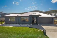 4 Porpoise Close Oakdowns TAS 7019 $610,000 If you have been wishing for your dream home to arrive then just maybe on the glimpse of the three hallow rings that draw your gaze from street to living could make that wish come true. Arriving at this property with the beautifully landscaped gardens highlighted against the dark colour palette of the residence and sight of the three rings illuminating through the large living area window sets high expectations of what is inside Once you enter through the grand glass front doors, justification is met with a generous open living area which encompasses the lounge, dining and well featured quality kitchen centered for function and highlighted by three suspended light rings that are simply mesmerizing A separate study positioned off the lounge area could become a versatile room to suit the needs and functionality of your family, which is a valued addition to this property. The sleeping quarters has two bedrooms with built-in robes and a master with walk-in-robe and a beautifully stone finished en-suite. The main bathroom replicates the en-suite in finish and styling while offering a deep free standing bath and offset shower area that is quiet an exclusive and unique space within this room. The double garage encompassing the laundry and is finished in a nice freckle floor offering an appealing space while providing excellent OSP and storage. There is also good secure yard space with a entertaining area which is internally accessed off the dining area and study. This property is superb in design, style and finish, offers excellent space, features and functionality while commanding an envious street presence day and night in a great location with views. These attributes makes this property an impressive offering indeed and one that could be yours FEATURES: • Air Conditioning • Built-In Wardrobes • Close To Schools • Close To Shops • Close To Transport • Garden • Study.