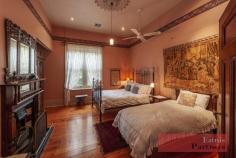 67-75 Buxton St North Adelaide SA 5006 $3,750,000+GST An outstanding Gentleman’s Residence of some 600 sqm of beautifully preserved and maintained accommodation of two stories, including a free standing 2 bedroom chauffeur’s cottage, so well situated on some 2,140 sqm (approx.) of land amongst stunning manicured gardens on one of North Adelaide’s most prized tree lined streets. Buxton Manor, circa 1908/9, was designed by well known Adelaide architect Fredrick Dancker for Adelaide solicitor F.J. Fisher. Other Dancker landmarks included “Adare” at Victor harbour, “Attunga” at Toorak Gardens, Botanical Gardens Headquarters and the Queen Victoria Hospital to name just a few. With its extensive use of decorative brickwork, exotic timbers, French Marseille tiled roof, Buxton Manor is a distinctive example of Adelaide’s Only Arts and Crafts Country house in the manner of William Morris. Currently disposed of as four massive apartments, plus a 2 bedroom cottage of 76sq metres, the property could continue as it is happily, or be easily re-converted back to the grand single residence it was prior to the second world war. There is an endless variety of uses that can be made of this amazing, versatile property. The present Vendors have owned Buxton Manor for over 30 years and lavished detailed care and maintenance on the property whilst keeping it purposely in its very original & pristine condition. It has had an illustrious social and cultural history befitting the grandeur of its built form. The home is currently configured as follows: Bedrooms: 10 Bathrooms: 5 Kitchens: 5 Reception Rooms: 6 Sunroom: 1 Laundry: 1 There are a myriad of wonderful and original architectural features of the early 1900’s era, including beautiful diamond leadlight windows, incredible plaster work, ornate mantle and over mantles, magnificent light fittings, and wallpaper friezes and hand French polished timber finishes throughout. The manor sits on massive bluestone foundation with extra thick 4 inch double brick cavity walls. Enter the property in style via one of the two brick driveways that deliver you into a world of a bygone era. Imagine your childhood in the beautiful well established gardens complete with delightful trees, standard roses, and expansive lawned areas. And its only 2km from the CBD! This is a rare, unique and exciting opportunity to purchase a Landmark property in this tightly held precinct of North Adelaide. Please call Richard Colley on 0418 827 710 to arrange a viewing.