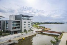 64/11 Trevillian Quay Kingston ACT 2604 Lakefront' on Kingston Island offers exclusive apartments on the shoreline of Canberra's premier waterfront precinct with nearby parks and national buildings including the National Gallery of Australia. Situated to the north of the new Kingston foreshore harbour, this apartment has water views of the canal,the East Basin of Lake Burley Griffin and Black Mountain Tower. With restaurants at your doorstep, Lakefront is only minutes to the Parliamentary zone, airport, railway station, Kingston retail centre, Manuka retail and movie theatre, and the City Centre. It is close to numerous entertainment centres. public transport and employment hubs. Located on level 4, Unit 64 offers a tranquil water outlook from the covered balcony and glass-walled living area with large glazed sliding doors. This 61m2 one bedroom unit has a floor plan which the architect has designed to make the most out of its aspect towards Lake Burley Griffin. Fixtures and fittings throughout the apartment are high quality with the ensuite bathroom featuring a luxurious stone top double vanity and stunning floor to ceiling marble tiles. Residents enjoy luxury resort-style living, including a fully equipped gym and a landscaped courtyard leading to an infinity pool for their exclusive use. Features overview: • Top level inclusions and fit-out • Secure allocated basement car space and storage enclosure • Lift access • Secure intercom entry to building for guests • Northerly outlook to Lake Burley Griffin • Unique floor plan with extensive use of glass to provide a light-filled residence • Ducted heating and air conditioning • Kitchen with marble floor tiles, stone benchtop and Miele gas cooktop, dishwasher and oven • Bathroom with stone top double vanity and floor to ceiling wall tiles • Well equipped gymnasium • Infinity swimming pool overlooking Lake Burley Griffin • Pet friendly (subject to body corporate notification)