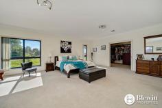 28 Beacon Place Googong NSW 2620 $2,100,000 With commanding 360-degree views from the top of the hill sits this grand residence sprawling over 557.1m2 under one roof line. There is an additional 113.7m2 of verandahs plus covered entertaining areas as well as garaging. The property has surveillance cameras, electric gate and intercom. Through the gate you are lead up the long tree and light-lined sealed driveway to the grand home. The home consists of a large formal lounge and dining room at the front that leads you to a stunning open plan kitchen and family meals area which overlooks the rear entertaining areas and gardens. The kitchen is an entertainer’s dream offering endless stone benches and storage. There is also a walk-in pantry that is large enough to get lost in. Down the extra wide hallway, you will find the massive rumpus/media room. This home offers a parent’s retreat like no other the size of which needs to be seen to be believed. This walk-in robe is fashionista’s dream and the large resort style ensuite offers spa, large shower, separate toilet and heated floors. The remaining 3 spacious bedrooms all offer built-in robes. This home offers two studies, the main study boasts its own entrance and is large enough to be split into 2 additional bedrooms. The second study is located at the opposite end of the home, providing flexible study/work from home options. There is a large three-way main bathroom which services the three bedrooms. Adjacent to this area is the functional and spacious laundry. At the garage end of the home there is a powder room. The oversized 3 car garage provides excellent storage and workshop space along with remote roller doors and internal access. There is also an oversized double garage perfect for any additional machinery. The fully fenced house yard is irrigated, landscaped and offers large level lawn areas along with easy care and established gardens including vegetable beds and fruit trees. There are front and rear covered entertaining spaces which overlook gardens and a stunning vista. The remainder of the property has been divided into paddocks with water troughs and shelter for stock. The current owners run Alpacas on the property. Features: – Grand formal lounge and dining room – Stunning open plan kitchen and family room – Large rumpus/media room – Retreat style master bedroom with walk-in robe and ensuite – Remaining bedrooms all spacious in size with built-in robes – Large home office offering its own entrance – Picturesque views from every room – Additional study at garage end of residence – 2.9m ceilings throughout – Double glazed windows throughout – Ducted reverse cycle air conditioning with 6 zones – Large covered entertaining spaces either side of the home – Oversized 3 car garage attached to house – Additional 2 car garage, 6m x 7m – Double carport attached to house – 110,000ltr concrete rainwater tank – Additional large water tank attached to shed – 500kl per annum bore water supply – 3 phase power to home – 240v power to front gate with driveway lights – 40+ solar panels – Sealed driveway – Automated irrigation system to gardens and lawns – 557.1m2 of house plus 113.7m2 of verandas 670.8m2 total covered – 2.41 Hectares (5.9 acres)