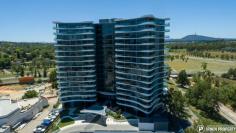 36/15 Irving Street Phillip ACT 2606 $499,000 Those looking for a home or investment property that offers access friendly features, genuine space, gorgeous views and resort style facilities are invited to inspect this stunning, as new apartment. THE HOME The large open plan living space consists of a lounge and dining area drenched in natural light from the generous floor to ceiling double glazed windows. Sliding doors lead out to the outdoor, covered balcony, the perfect spot to enjoy your favourite drink and enjoy its panoramic views. A chef's dream, the kitchen is beautifully finished with stone bench tops, generous storage and two-tone cabinets. Appliances are quality Smeg items including the induction cooktop. The European style hide-away laundry is integrated within the kitchen space and includes a washer/dryer. There are two full size bedrooms, at opposite ends of the apartment, adjacent to their own bathrooms. The main bedroom features a walk-in robe and second bedroom has a large built-in robe. The bathrooms are of standout quality with floor to ceiling tiling, generous storage & high-end finishes that will impress. Ensuring everyone is comfortable year-round are three Panasonic split system air conditioners. Secure basement parking is included for two vehicles, one being an extra wide accessible space, plus there's additional lockable storage. 'Ivy Woden' residents enjoy use of the rejuvenation centre with indoor and outdoor pools, a spa, sauna, separate weights and cardio gyms, both indoor and outdoor yoga spaces, an outdoor bowling green and outdoor entertaining/recreational areas. THE LOCATION 'Ivy Woden' is perfectly positioned, only minutes to Woden Town Centre including a number of major government agencies, Westfield Shopping Centre, Canberra Hospital, Calvary John James Hospital, public transport options plus a growing list of cafés and restaurants. The apartment is just 8km from the Parliamentary Triangle making cycling to work a breeze.