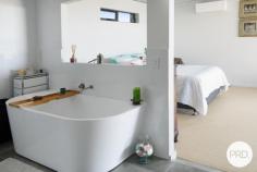 4 Coastwatch Close KORORA NSW 2450 $1,375,000 - $1,425,000 Located in one of Korora's most sought after enclaves, this 4 bedroom architecturally designed home delivers the best of coastal living and is only footsteps from the sands of Korora Bay Beach. The grandeur of this home with its size and architecturally curved roof line, you will appreciate that this home is in a class of its own. Designed over 3 levels, the floor plan provides private spaces for all members of the family, capturing the ocean views and northerly aspect. Level 1 offers large living and dining spaces for relaxed family living and the natural warmth of the polished timber floors adds ambiance to the home. The high-end entertainers kitchen with stone benchtops and sleek cabinetry is well appointed and fuses the outside entertaining area with indoor living, taking advantage of the sea breezes. There are 2 queen size bedrooms and the media/cinema room on this floor. On the upper floor there is a master suite with its own balcony including a huge luxury en-suite and walk-in robe as well as a lounge area providing a private space and commanding views out over Korora Bay. On the lower level there is a 4th bedroom with ensuite that overlooks the pool and gardens. There are so many features in this home including the revolutionary Ritek triple insulated roofing system that has a high thermal rating reducing energy costs, auto oversized triple garage as well a huge storage area currently used as a home gym. There is even a spare room that could be used as a work from home office. The beautiful outdoor areas lovingly wrapped around tranquil gardens are the real standout with an amazing (10x5m) in ground swimming pool and deck complete with built-in entertaining gazebo designed to create a perfect beachside lifestyle.
