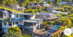 4 Coastwatch Close KORORA NSW 2450 $1,375,000 - $1,425,000 Located in one of Korora's most sought after enclaves, this 4 bedroom architecturally designed home delivers the best of coastal living and is only footsteps from the sands of Korora Bay Beach. The grandeur of this home with its size and architecturally curved roof line, you will appreciate that this home is in a class of its own. Designed over 3 levels, the floor plan provides private spaces for all members of the family, capturing the ocean views and northerly aspect. Level 1 offers large living and dining spaces for relaxed family living and the natural warmth of the polished timber floors adds ambiance to the home. The high-end entertainers kitchen with stone benchtops and sleek cabinetry is well appointed and fuses the outside entertaining area with indoor living, taking advantage of the sea breezes. There are 2 queen size bedrooms and the media/cinema room on this floor. On the upper floor there is a master suite with its own balcony including a huge luxury en-suite and walk-in robe as well as a lounge area providing a private space and commanding views out over Korora Bay. On the lower level there is a 4th bedroom with ensuite that overlooks the pool and gardens. There are so many features in this home including the revolutionary Ritek triple insulated roofing system that has a high thermal rating reducing energy costs, auto oversized triple garage as well a huge storage area currently used as a home gym. There is even a spare room that could be used as a work from home office. The beautiful outdoor areas lovingly wrapped around tranquil gardens are the real standout with an amazing (10x5m) in ground swimming pool and deck complete with built-in entertaining gazebo designed to create a perfect beachside lifestyle.