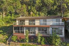 98 GLENROCK PARADE KOOLEWONG NSW 2256 Nestled in a private, elevated position with National Park to the back and uninterrupted water views to the front, this fantastic home is situated on 1151sqm spanning two levels has been designed with versatility in mind. With each level being completely self-contained it is perfect for the extended family to move right in or to start renting one or both levels out permanently, or as an Airbnb escape. The top level boasts 3 bedrooms, a family bathroom and an open plan modern kitchen, dining and living area which opens out to a huge entertaining deck with spectacular water views, as well as a back deck with mountain and bush views. The bottom level comes complete with master bedroom and en suite, kitchenette and living area and also has two decks and amazing views. As a rare bonus, the property also offers a double lock-up garage and parking space for additional cars. Top floor features include: - Expansive water views across Brisbane Water - Two double bedrooms with built-in robes and direct access out to the deck - Family bathroom with separate bath and shower - Open plan modern kitchen, living and dining extending out to a huge entertaining deck - Timber floorboards - Split system air conditioning and a slow combustion fireplace - Large and private back deck with peaceful and natural surrounds Lower floor features include: - More wonderful views and two decks to soak them in from - Master bedroom with built-in robe and en suite - Timber floorboards - Spacious open plan kitchen and living area With shops, transport, nature and the waterfront all at your fingertips, this truly is the perfect retreat.