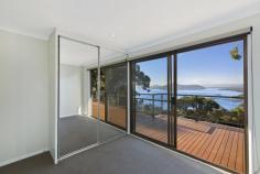 98 GLENROCK PARADE KOOLEWONG NSW 2256 Nestled in a private, elevated position with National Park to the back and uninterrupted water views to the front, this fantastic home is situated on 1151sqm spanning two levels has been designed with versatility in mind. With each level being completely self-contained it is perfect for the extended family to move right in or to start renting one or both levels out permanently, or as an Airbnb escape. The top level boasts 3 bedrooms, a family bathroom and an open plan modern kitchen, dining and living area which opens out to a huge entertaining deck with spectacular water views, as well as a back deck with mountain and bush views. The bottom level comes complete with master bedroom and en suite, kitchenette and living area and also has two decks and amazing views. As a rare bonus, the property also offers a double lock-up garage and parking space for additional cars. Top floor features include: - Expansive water views across Brisbane Water - Two double bedrooms with built-in robes and direct access out to the deck - Family bathroom with separate bath and shower - Open plan modern kitchen, living and dining extending out to a huge entertaining deck - Timber floorboards - Split system air conditioning and a slow combustion fireplace - Large and private back deck with peaceful and natural surrounds Lower floor features include: - More wonderful views and two decks to soak them in from - Master bedroom with built-in robe and en suite - Timber floorboards - Spacious open plan kitchen and living area With shops, transport, nature and the waterfront all at your fingertips, this truly is the perfect retreat.