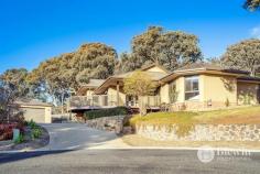 7 Applebox Place Jerrabomberra NSW 2619 Located at the end of a quiet cul-de-sac and backing open bush reserve you will find this spacious and grand architecturally designed four bedroom and two bathroom family home with stunning views. At the front of the home the formal lounge room is flooded with natural north facing light and opens onto the entertaining deck which offers stunning views. The formal lounge and dining both feature solid timber floors and glass sliding doors out to the entertaining areas. The large open plan kitchen and family room boasts extra high ceilings and windows which also capture the north facing light. The kitchen offers stone benches and an abundance of storage. At the front of the home, you will find two spacious bedrooms with built-in robes and a bathroom. At the rear of the property, are another two large bedrooms with built-in robes. Here is also home to the main bathroom with separate toilet and large laundry with excellent storage. The property has been designed to be solar passive with double glazed windows throughout, high ceilings and ducted reverse cycle air conditioning. Outside the home boasts multiple entertaining areas, a large north facing wrap-around deck, lawn areas and a long dive way leading to the oversized double garage with remote roller door and built-in bar. Features: – Spacious solar passive design offering views from every room – Large formal lounge and dining room – Open plan kitchen family room – Large kitchen with stone benches – 4 king-sized bedrooms all with built-in robes – 2 generous sized bathrooms – Laundry with storage – Double glazed windows with argon gas throughout – Ducted reverse cycle air conditioning – Oversized double garage with bar – Large wrap-around deck with north facing views – Landscaped gardens with level lawn and multiple entertaining areas – Backing and siding reserve with direct access to the open bushland offering walking and mountain bike trails – Sensational location at the end of a quiet cul-de-sac