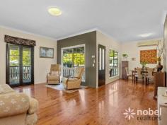 The heart of the layout is the open-plan and air-conditioned living and dining room with French doors that open to the covered entertainer’s deck. This is the ideal setting to start the day with a morning coffee or host guests for a delicious meal as you immerse yourself in your new life of leisure. Gleaming timber floors flow underfoot throughout including in the large and open kitchen. Preparing meals is made easy thanks to the sweeping benchtops and abundance of storage plus there’s a collection of all-white appliances and a tiled backsplash. Whether you’re an everyday master chef or you simply love preparing meals for friends and family, you’re sure to feel right at home in this culinary haven.