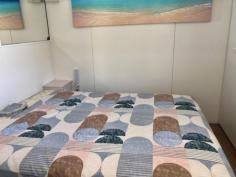 70/396 Princes Hwy Ulladulla NSW 2539 $195,000 Beachside Village, is a quiet and tranquil park that backs on to the beautiful Racecourse Beach in Ulladulla. You are literally minutes from dipping your toes in the sand and enjoying a swim in the ocean. Have your morning coffee on the sea view deck and watch the whales go by. This village park is only a 2-3 minute drive into Ulladulla CBD where you can enjoy many restaurants, shopping and entertainment. The park is very friendly and definitely has a village community feel to it and is surrounded by an open nature reserve. IMPORTANT: occupation is only 182 days per year. You can rent it or holiday let it out but you will be using your 182 days. Park fee $134 per week. Gas/electricity to be paid by owner. The unit offers – – Good sized lounge with ocean views – Renovated kitchen with timber bench and plenty of workspace and cupboards – gas cooktop – Meals table in the kitchen – Two good sized bedrooms – Bathroom with shower, vanity and W/C – Heating and Cooling – Huge concrete car space – Bottle gas – Land is approx.. 10x 9.5m2 – Furniture is WIWO – this property has a cute retro feel about it – Only a two minute easy flat walk to the beach The park offers – – The units in the park are only to be used for up to 182 days – You could potentially rent it out for holiday letting for up to that 182 days but you would be using those days – You can have up to 2 small dogs – Enclosed and outdoor camp kitchen – Outdoor BBQ..