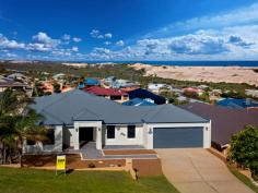 56 Bellimos Drive Wandina WA 6530 Situated in the heart of Bellimos Drive, this property is simply oozing with quality, a modern feel and executive living. This home was designed to capture an unobstructed ocean view from the open kitchen, living and bar area, offering an outlook to the back yard. This is your comfortable private space with a lovely elevated outlook. Other appealing features include: Good sized, master bedroom with a walk-in robe ensuite bathroom & split system air-conditioning Three queen-sized minor bedrooms with built-in robes and two minor bedrooms with ocean views Separate formal lounge/theatre Large gable patio, over looking the lawn and garden area Double garage allowing access to the patio Great sized, easy to maintain back yard Functional laundry with storage space