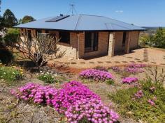 10 Rosalie Dr Yarraman QLD 4614 $450,000 This 3 bedroom brick home is set on 4041m2 on a corner position . The house has an ensuite, built-ins, ceiling fans , reverse cycle air con. , security screens, tinted windows , insulation , 5w solar power & town & tank water. The modern kitchen has a an electric oven, cook top, rangehood & dishwasher, two way , giving entry to the dining room & lounge room. While you are sitting on the patio having a cuppa, you get to relax, with the great views over looking the township of Yarraman. This property has well established terraced gardens, Plus a 3 bay all steel garage (approx. 20mt x 9mt ) with an entertainment area, toilet, shower , pot belly wood heater, stove , & enough room to store a large caravan in the carport,