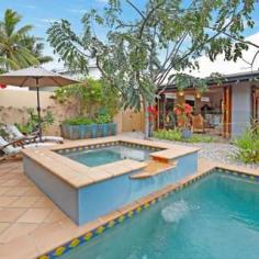 3 Trivia Street, Palm Cove, QLD 4879 HOUSE FOR SALE IN PALM COVE STUNNING BEACHSIDE PAVILION RESIDENCE AT AN EXCLUSIVE ADDRESS 4 Beds 2 Baths 2 Cars An immaculately presented home in the heart of the Golden Triangle of Palm Cove where the Mediterranean meets Tropical North Queensland. The blending of architecture with bespoke design features and stylish decor makes this elegant residence a cut above the rest. Located opposite Tom McDonald Park, and just a three-minute stroll to Cairns' premier beach, this home is in the best street, in the best suburb, north of Brisbane. Designed and built by Chris Blanche, this breathtaking private residence comprises two pavilions where its engagement with the tropical surrounds welcomes the outdoors in, all year round. The impressive entrance entices you across an enchanting timber bridge over twin fishponds surrounded by exotic tropical plants, setting the tone and welcoming you into an open courtyard between the two pavilions. The front pavilion houses the open kitchen, lounge, dining, and covered alfresco entertaining areas, all of which overlook the pool, the spa and the lush tropical verge surrounding the property. The rear two level pavilion features three ground floor bedrooms, bathroom, laundry, guest toilet and ample storage; while the parent's retreat master bedroom is on the upper level complete with WIR and ensuite. This level has wrap around windows offering a picturesque view across to leafy expanse of Tom McDonald Park, a view which is framed by the large Pandanus palms directly below. This beautiful home lends itself to entertaining in style as the front pavilion houses natural timber concertina and French doors that open onto the covered patio and terracotta tiled pool area, opening the entire living area up and inviting the outdoor ambience in. With a recent kitchen makeover, the installation of solar heating. LED lighting, eco ceiling fans and window tinting, this home is perfect for families and friends to enjoy being part of the Palm Cove luxe resort lifestyle. There is so much to love: A fully fenced 700 m2 block with professionally designed gardens, complete with fully functioning water reticulation system Bespoke wrought iron gates and ironwork by Elefantus Double remote garage with lots of storage Solar panels installed Heat resistant protective paint applied to roof High ceilings throughout and wide walkways Fully air conditioned Kitchen with breakfast bar, gas cooking, and granite bench tops Extensive custom-made timber windows, louvres and doors Security and insect screens Just a short stroll from your new home is the beautiful palm fringed esplanade of Palm Cove where you will find an array of fine dining restaurants, casual cafes and boutique shopping. Ray White Smithfield For your private inspection, contact: Matthew Pearce 0418 708 758 Simon Batt 0400 932 229 Land: 700m² / 0.17 acres Parking: 2 garage spaces Bedrooms: 4 Bathrooms: 2