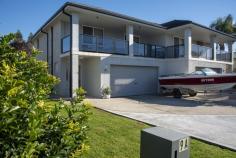 2/9 Witherington Ave Ulladulla NSW 2539 Enjoy easy care living in this immaculate duplex offering incredibly spacious living and generous rooms throughout. The living areas and gourmet kitchen, bathroom and laundry are on the ground floor with access to the private courtyard with covered patio and fully fenced grassed yard. The home features a wide staircase with chair lift already in place for long term living leading to the upstairs bedrooms, the main with luxury ensuite and walk-in-robe. With a spacious double garage and plenty of off-street parking, there is space for everything. Spend your mornings on the upstairs balcony taking in the distant ocean views, or take a short stroll into Ulladulla and take advantage of having the CBD, restaurants, schools and harbour on your doorstep.