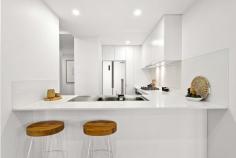 101/6 Beatson Street Wollongong NSW 2500 Impressively sized and crisply appointed, this quality courtyard apartment offers an idyllic urban retreat in one of Wollongong's premier pockets. Designed for elegant impact, interiors feature generous banks of floor-to-ceiling glass, a sleek snowy-white kitchen with stone benchtops, and chic alfresco flow from both the lounge and dining areas. The main bedroom boasts its own courtyard and a spacious ensuite; sleek new floating floors carry the home's stylish theme throughout. Just a stroll away from cafes and City Beach, this is an outstanding opportunity for comfort and convenience. Features: Beautifully bright + private with distant escarpment views Full width all-seasons courtyard, leafy attached garden Gas-equipped kitchen with dishwasher and breakfast bar Main bath with freestanding tub; separate internal laundry Built-in robes throughout, intercom, secure parking space Easy walk to golf course, MacCabe Park, transport + CBD.