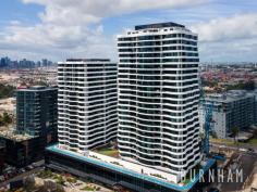 2206/8 Hallenstein St Footscray VIC 3011 $575,000 - $625,000 Enjoy awe-inspiring, unobstructed, sweeping views of the Maribyrnong River and Flemington Racecourse in this new, luxe and spacious two-bedroom apartment. Perfect for first homebuyers and investors alike. Upon entry, timber floors guide you to the open plan living and dining area. This space features curved panoramic windows that allow light to fill the room and frame the views of the surrounding landscape. Indoor/outdoor entertaining is made easy as this area opens to the entertainer’s balcony where the outlook is truly breathtaking. The homes kitchen fuses style and functionality. It boasts extended stone bench tops, Bosch stainless steel appliances, integrated fridge, hexagon splashback tiles, black hardware and an abundance of storage. The master suite is large and light filled featuring curved, wall to wall windows. It is serviced by an ensuite with a large shower. The second bedroom follows similar trends with racecourse and river views. Both bedrooms feature luxe charcoal carpeting and substantial, mirrored built-in robes. The central bathroom features shaving cabinets, floor to ceiling tiles, hexagon feature tiles, black tapware and a large shower with rainfall shower head. The apartment is completed by a European laundry and separate linen cupboard. Enjoy all the amenities Vic Square has to offer, including, the sky garden on level 4, a fully equipped gym, pool, games room with billiards table and cinema. If that isn’t enough, located only 6kms from the city, take advantage of its close proximity to everything your heart desires. Footscray’s burgeoning bar and restaurant scene, Victoria University, Footscray Train Station, the Maribyrnong River, bus and tram tops and Footscray Park are a short walk away. Additional features: – Split system air conditioning and heating in the lounge – Window furnishings – Secure intercom entry – Designated spot in secure, underground car park.
