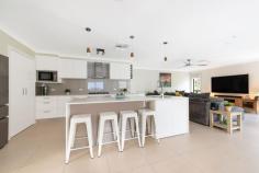 32 Warrumbul Street Ngunnawal ACT 2913 $1,399,000+ Every square inch of this stunning home has been meticulously painstakingly (no cost spared) re-furbished somehow! You’ll be impressed by the presentation of the front garden, its setback & privacy from the road & the ample car parking space available. Next, you’ll be greeted with an extra-wide entry with a blend of oversized porcelain tiles & real hardwood floor creating the homely feel in the formal lounge & dining. French & glass doors are found throughout the living spaces & corridors maintaining the natural light throughout this gorgeous home. A totally renovated & extended kitchen, the home’s heart will impress even the biggest of home dining entertainers with the latest modern up to date finishes & fixtures boasting ample bench space preparation areas, quality cooking appliances & customised fitted out walk-in pantry. Space is certainly not lacking in the open family room, which looks over the rear yard & yields access to an entertainer’s absolute dream! Recently refurbished deck flooring, quality pitched roof with new sun tuff UV roofing including fans overhead and you have an outdoor entertaining oasis with kitchen & spa. You’ll the envy of all your family & friends all year round. Segregated down the “hallway that runs forever” are both bathrooms, separate toilet & laundry, all extensively refitted with modern creature comforts. Bed 4 has been converted into an office with built-in cabinetry comfortable for two people to work from home or a great space for children to study. Built-in robes in bedrooms 2,3 & 4 have been converted to sliding door systems & the internals with all new custom cabinetry. The sizable master has a transformed ensuite & custom fitted cabinetry in the walk-in robe. You’ll also find internal access to the oversized double garage with a mancave workbench space with overhead cupboards & a 5th room storage. The Owners’ Favourite Part: Being able to sit out on the back lawn & watch the view of sky fire across the black mountain tower. We wish we could take this home with us. Features: – Evaporative Cooling – Ducted Gas Heating – In slab underfloor heating – Security system – 8 X external security cameras (recorded) – Underground storeroom – Side 5m X 3m carport – Outdoor Kitchen.