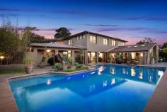 46 Maitland Street Davidson NSW 2085 $2.9 million This stunning contemporary home features an amazing pool and entertaining area, flush with a huge entertaining gazebo with BBQ, all overlooking the resort style pool. Come home from work to relax or entertain. Constructed of brick and tile this home has been completely remodelled, it presents freshly painted, with new kitchen and bathrooms, new floors and landscaping. Set on the high side of the street with amazing views over bushland to Gordon and St Ives, the home is breathtakingly private with no one overlooking you, and hidden behind large brick fences. Entrance is alongside the garage through a security gate with Intercom and camera, this leads to a large, covered walkway between the house and the pool area. The home features two totally distinct living areas that both flow through French doors to the covered deck and pool. The casual living area leads off the garage and has a bathroom & toilet that services the pool and lower level of the home, the other living area flows from the kitchen and also features the dining room, it also flows through opposing French doors to the rear yard and pond. It features timber floors, raked ceilings, split system aircon & is full of light. The modern kitchen features granite benchtops with waterfall edges & stainless appliances, dishwasher and a double bowl sink overlooking the garden through the huge picture window. Upstairs you have 4 bedrooms, plus 3 bathrooms, all with built-ins or walk in wardrobes, plus timber louvers on windows, ducted aircon throughout the upper level, three of these are King or Queen sized. The main bedroom features a master retreat alongside the King size bedroom, this leads to a huge new ensuite with full length tiling and double bowl vanity. The main bathroom is new with full bath and shower modern vanity & full-length tiling. The easy-care gardens feature a decorative fish-pond in yard plus entertaining area overlooking elevated bush views to Killara and St Ives. The huge resort style pool feature underwater lights, plus solar heating to lengthen the swimming season, and huge Cabana with BBQ to get away from the sun. Garaging has parking for 2 + cars in the double lockup garage with internal entry & electric door, plus plenty of storage or workshop room, plus parking on the driveway for a further 4 cars. Other features include timber floors throughout, freshly painted throughout, downlights throughout, close to local schools and transport, overwhelmingly quiet & private.