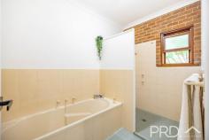 21 Cromwell Street Adelong NSW 2729 Set amongst manicured park land and bound by Adelong Creek and the local Showground, sits this beautifully presented four-bedroom, two-bathroom, double brick family home. Located on the very edge of town and offering the perfect lifestyle opportunity for those that also desire the comforts of town living, an opportunity such as this is sure to not last long. Call today to book your private inspection! Premiere Features: - Four bedrooms, all with built in robes and master boasting split system air conditioning - Three-way main bathroom with separate shower and bath area, powder area with large single vanity and separate toilet - Second bathroom boasting shower and toilet accessed privately through the laundry - Large open style kitchen overlooking the rear yard with gas cooktop, ample bench space and large walk-in pantry - Centrally located dining area with gas heating, split system air conditioning all free flowing from the major living and the rear outside entertaining - Large sun filtered open plan living area with polished cypress pine flooring and built in cabinetry - Additional rumpus room to one end of the plan - Great size internal laundry - Large fully covered rear deck looking over the tranquil and established grounds - Vine covered pergola to the front with additional outside entertaining area - Single carport - Linen in hall - 13m x 7m shed positioned privately to the rear of the home and boasting large private hobby room, stainless commercial sink, additional shower and toilet - 9m x 2.5m carport awning off the side of the shed - Purpose built 4m x 3m semi underground wine cellar with built in storage - Built in outdoor wood fire pizza oven - Spacious established gardens with quaint orchard (citrus and stone fruit) and vineyard (73 grape vines) - Fully equipped electric powered bore - Established reticulation and dripper systems - Chicken yard and coup - 3kw Solar power and hot water system - All town services including power, water, sewage, natural gas and garbage service - Absolute creek front with direct access at the rear of the property - Approximate 2.57-acre allotment on the very edge of town This exceptional lifestyle property offers the best of both worlds and is sure to not last long, call today to book your private inspection!