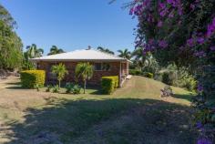 29 MIFSUD DRIVE SARINA BEACH QLD 4737 $720,000 When inspecting, please enter "Misfud" into Google - incorrectly spelt on all Google sites). A bitumen 20min drive from the City Gates presents this immaculately maintained property, tucked into the summit of a hill with panoramic views, constant ocean breezes, abundant soil, a well-designed family home & sheds to accommodate multiple vehicles or machinery! The four-bedroom home offers views from every window & boasts a neat ensuite off the master. All bedrooms are well-sized with three of the four having built-in wardrobes with fans, carpet & air conditioning. The fourth bedroom is currently used as an office & storage room but could easily be converted if wished. Upon entry, the lounge is defined with interior dark brick arches that have the effect of an open space, leading to the open plan dining room & flowing into the well-appointed large kitchen. Cook for days with endless views of the mountains whilst enjoying ample bench space & plentiful overhead & underbench cupboards. The breakfast bench is at the entry of the kitchen & is fantastic for casual cuppas or kids doing homework. Right beside the breakfast bench is internal entry into the house from the lockable garage, which is very appreciated when lugging groceries into the house. The undercover enclosed patio acts as a lovely entry area &, being surrounded with security screens, could be a beautiful greenhouse or entertaining area. Step out of the lounge or dining room to concrete covered patios where you could watch the world go by without a worry, enjoying endless views & constant cool breezes. Landscaped gardens & established abundant fruit trees/vegie patches/herb gardens are evidence of years of lovingly devoted toiling to produce the healthiest & naturalist that Mother Earth can provide! The shed will be the envy of every Man-Cave-loving-male with 10 bays (5 bays fitting 2 cars in tandem in each bay). 4 massive doors open outwards for easy access & the 5th bay has been converted into a shelved workshop/"office". With power, windows for breeze, shelving that stays, a hard-wired welder etc, move straight in & begin work immediately! Expenses are at an all-time low at this address with solar panels; 3 x 6000 gallon rainwater tanks; 2 x 6000 gallon bore water tanks; pottable bore water; septic sewer system & grey water used on the grounds for all year lushness. This property is just divine! It oozes of family memories, loving get-togethers & fantastic memories for any children lucky enough to be raised in the healthy outdoors with memories of exploring the grounds; riding the resident horse (included in the sale) & toasting marshmellows around the firepit. With a very short drive to both Sarina & Mackay, come home each day to totally switch off & relax, being so close to the beach. Be incredibly quick to inspect this tightly-held, highly sought-after beautiful family home & adopt the accompanying lifestyle of peace & tranquillity!