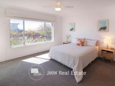 12 Castleroy Terrace Dunsborough WA 6281 Custom designed and built to make the most of its elevated northerly aspect, this solar passive home optimises natural light and breezes, keeping it warm in winter and cool in summer. It is also deceptively spacious, with a footprint of 238sqm approximately. Located in a low traffic zone, just 100m from the 8th tee and a street back from the picturesque Blue Water Lake. Enjoy the beaches just minutes away, walk or ride to cafes, restaurants, bars, shopping centres, Community Centre facilities and sporting grounds. Dunsborough Lakes Golf Course is just 1 km down the road where you can enjoy a drink or meal at the tavern after playing a game on this premier course. The Castleroy Crescent street entrance leads you upstairs & across a spacious decked alfresco area, surrounded by low maintenance, colourful gardens. The timber decking extends well beyond the roof cover and includes a built-in day bed complete with artificial lawn. Clever planning to make the most of the terrace feel and views, mean that the “grassy box” is a quiet, sunny place for both your morning coffee and an afternoon relaxing drink with family and friends, perhaps while watching the AFL on an outdoor television, both an antenna and power point are installed. The high 31 course ceiling of the alfresco continues into the main living area from the deck. With adequate room for a dining table plus family area, the living space is flooded with winter sun through the oversized window that overlooks a feature garden and a second sliding glass door provides access to a separate decked area. Most of your time will be spent in this open plan entertaining hub of the house, which is complimented by a Jarrahdale wood fire burner for those winter nights to sit and enjoy a wonderful Margaret River red wine. The open plan living zone is overlooked by a spacious and well-appointed kitchen featuring a massive breakfast bench/prep area, modern appliances, such as a Bosch dishwasher and 5 burner gas cook top, spacious walk-in pantry and a generous amount of soft close drawer space. The theatre room with double door entry is positioned away from the main living area and completes a functional layout for living with either a young family or older children. It can easily be utilised as a fourth bedroom / guest room, gym or office space. The oversized master bedroom benefits from its north-eastern aspect with lovely sunshine in the mornings. Window tinting, gardens and 100% block out blinds afford it plenty of privacy. A king size bed plus bedroom suite in here still leaves ample floor space. Further features are a wall mounted TV, ceiling fan and raised ceilings which continue through the ample His/Hers walk through robes and open en-suite, which offers a walk-in shower, large vanity, heat lamps, heated towel rail and separate WC. The second and third bedrooms are queen size and can easily accommodate a study desk if required, both feature mirrored sliding door double robes. They are serviced by a central well-appointed bathroom with full size bath, shower, large vanity and cupboard, adjacent to a linen cupboard and WC. The laundry has a large workable bench top with space underneath to put both washer and dryer, an indoor drying rack and access to outdoor clothes drying area. Here you will find the electric booster for the solar hot water. In addition, there is a 1.5KW electricity system with 3KW inverter suitable for additional panels to save even more on your power bills. Brechin Lane at the rear gives a second residence entrance where you can access the remote double garage, garden and “back” door. The oversized double garage not only has heaps of storage space and sensor lighting but is also high enough to fit a large 4WD and includes a built-in work bench for all your workshop needs. From here you have access to a cold outdoor shower or directly into the laundry.