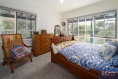 335 Hazel Park Rd Welshpool VIC 3966 $785,000-850,000 Complete privacy surrounded by approx. 4.8 acres of land with a long tree lined driveway leading you home. Charming residence amidst picturesque rambling cottage gardens, orchard, vegetable patch, 4 fenced paddocks and excellent shedding. With wide verandahs on two sides there is always somewhere to sit and catch the sun, listen to the birds, enjoy the peace and quiet. Pretty entrance foyer leads into the spacious open plan interior with easy care polished flooring. The ambience of a wood heater is combined with the convenience of RC/AC to ensure comfort in every season. Every window enjoys views of the stunning garden setting, bringing the outside in to connect you with nature. Modern kitchen with quality appliances, huge walk in pantry and island bench / servery to dining area. Light filled sunroom / studio space or study. Three double sized bedrooms, family bathroom, laundry / utility room and separate w.c. Minimal running costs with solar and mains power and solar hot water. Shedding includes a 3 bay lockable shed with concrete floor, lights and power plus a 3 bay extra height, chook pen, disused dairy and hay shed. Excellent water storage. Quiet rural location just 8 minutes from Agnes Falls with Toora (7 minutes) and Welshpool (8 minutes) a short sealed drive away.