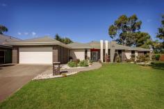 41 Champions Drive Glenroy NSW 2640 Nestled on a large lot within the highly prized Hume Country Estate is this sublime family retreat. Complete with a large layout, lush gardens and private estate parkland views, this is your chance to truly have it all. The floorplan has been designed with family living in mind with four bedrooms and two bathrooms including a private owner's suite with a walk-through robe and ensuite. The three guest bedrooms all have built-in robes and are tucked away in their own wing alongside the main bathroom and the laundry. The heart of this haven is the big and beautiful kitchen with quality appliances including a wall oven and a gas cooktop. There is plenty of storage space and a fantastic breakfast bar where friends can gather as you show off your culinary skills. When it's time to relax, you're spoilt for choice. A host of gathering spaces are on offer from the cosy living room with plush carpet underfoot to the light-filled family room with a high ceiling and views over the yard. Meals can be enjoyed in the dining area or you can step out to the expansive alfresco and soak up the sunshine as you overlook the landscaped gardens. A double remote entry garage connects to the family room. Ducted heating and cooling ensures year round comfort. Outdoors will impress offering privacy the garden shed adds added storage space. This must-see home enjoys an enviable location just moments from parks, close to Glenroy Public School and only moments from all the shops and cafes you could need.