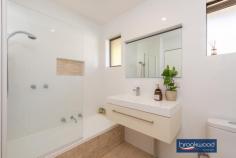 9C John St Midland WA 6056 This 2-bedroom, 1-bathroom property occupies a remarkable 409 sqm lot at the rear of a small unit complex. An open-plan kitchen/meals extends onto a large alfresco entertaining area edged with lawn and a screen of established trees. A rare find in a central location with the atmosphere of a small home, this unit is not to be missed. 2 bedrooms 1 bathroom 1979-built brick and tile Rear small unit complex Open plan kitchen/meals Fully tiled reno’ed bath Big gabled alfresco living Gated two-car carport Reticulated lawn & garden Surprising 409 sqm block Close schools shops transp Boasting the backyard of a small home with a large outdoor entertaining area, lawn, and reticulated gardens, this unit nestles at the rear of a 5-unit complex. Surrounded by greenery, the home features a single carport with gated access to the backyard and a welcoming portico entry. A north-facing window, fresh white walls and rich timber-look laminate floors offer a bright welcome as you step inside the family room. This palette of colours and materials continues in the adjoining kitchen/meals area, creating a visual flow and a sense of cohesion. The kitchen is well-appointed with ample under bench and overhead storage, a U-shaped benchtop with an integrated breakfast bar and a freestanding oven. There is ample space in the meals area for a full-sized table, but this property is designed to encourage alfresco dining. A sliding door opens the kitchen/meals area to a big, beautiful patio sheltered by a high gabled roof. Established plantings along the property’s fence line create a private, secluded space with room for entertaining and an exceptional sense of space Two good-sized bedrooms share the fully-tiled renovated bathroom. An on-trend neutral palette creates a light and airy space with a delightfully modern vibe. Set in a great central location, close to public transport, the Midland Health Campus and Midland Gate shopping centre. St Brigid’s Primary School and the North Metropolitan TAFE are within walking distance of this unit with more.