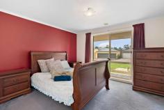 38 Manorwoods Drive Frankston VIC 3199 $870,000 - $957,000 Striking architectural lines and spacious design make a wonderful impression in this comfortable family home set on a large garden allotment fringed by tall palms and beautiful birds of paradise. Long-held and well maintained yet with scope for little updates if desired, the residence flaunts three living areas, including a sunken lounge adjacent the master and a light-filled living room with plush carpeting and bay windows. A large family/meals area with ceramic tiled flooring sits beneath a soaring raked ceiling, while both the living room and family room flow out through sliding glass doors to a long north-facing patio to entertain outdoors backdropped by the swaying palms. Light timber veneer cabinetry and stainless-steel appliances define the family kitchen, which shares the luminous northerly aspect in this well-designed layout, which includes a plush master with walk-in robe and ensuite and a full second bathroom which includes a spa bath in the junior wing. A short walk to Karingal Heights Primary School, Havana Reserve and the local milk bar, the property is just a stones throw to the Peninsula Freeway, a 4 minute drive to the major shopping of Karingal Hub shopping centre and the endless recreational facilities of Ballam Park. Set on the court of a 752m2 (approx) allotment, the residence includes ducted heating, evaporative cooling, a dishwasher and a double garage with internal access.