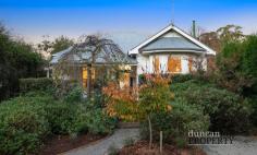 62 Bendooley St Bowral NSW 2576 Radiating every inch of its c1895 character and charm, this classic cottage is set back from the road and occupies a glorious leafy land parcel of just over half an acre. Original features are perfectly intertwined with more modern elements to deliver a beautiful foundation on which to add your own mark. A second one-bedroom residence presents a fantastic opportunity for income supplementation or dual living, and the addition of a separate studio in the sprawling backyard really is the icing on the cake. Please let us introduce you. Main Residence: Gas central heating⎪Gas bayonet point Combined lounge and dining room⎪Built-in bookshelves Kitchen with gas cooktop⎪stainless steel splashback⎪walk-in pantry Original timber floors⎪Sisal carpet Combined bath/shower and underfloor heating Built-in wardrobe in bedrooms 1 and 2⎪Built-in shelving in bedroom 3 High ceilings⎪Picture rails Separate studio with attached workshop Laundry with extra w/c⎪Storeroom Off-street parking⎪Garden shed⎪Chook pen⎪Cubby house Residence 2: Gas bayonet point Open plan living and dining Kitchen with electric stove Bedroom with sunroom⎪Sleepout Combined bath/shower$2,250,000