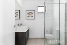 94 Alexander St Footscray VIC 3011 $850,000 - $900,000 This modern, cosmopolitan home fuses contemporary and low maintenance living to create the ultimate townhouse lifestyle. Located in the burgeoning suburb of Seddon, with its own street frontage, the value and appeal of this home is only set to grow. Upon entry to the home, you are greeted with bright spaces and impressive timber floors. The open plan living and dining area is an entertainer’s dream, this zone opens to the private courtyard, creating a peaceful ambience by bringing the outdoors in. The heart of the home, the kitchen, is sure to impress with grand proportions. It features a smoke mirror splashback, gas cooktop, stone benchtops, a double sink, island bench/breakfast bar, and ample storage space. The lower level is completed by a light-filled study, allowing for pleasant work from home situations. The airy master suite on the upper level is serviced by an ensuite with a large shower and vanity with storage. The second bedroom has ample space and overlooks the street below, making it the perfect place to unwind after a long day. This bedroom is serviced by the central bathroom that is wrapped with neutral tones and features a shower and vanity with storage. Located approximately 8kms from the city, enjoy an abundance of amenities at your doorstep. Middle and West Footscray train station, parklands, Victoria and Charles street shops and cafes, Footscray city and numerous schools are within a short walk. Additional features: – European laundry – Split system heating and cooling in the bedrooms and living area – Carport – Private courtyard