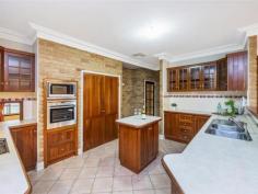 10 Sherbrooke Heights Noranda WA 6062 Sitting proudly amongst homes of distinction on arguably Noranda’s most prestigious street, lies this resplendent, double storey Federation Inspired manor. Designed to cater for the largest of families with 5/7 bedrooms, 4 bathrooms, 4 separate living areas, wrap-around alfresco overlooking pool and off street parking for up to 11 cars, the space and versatility it offers is simply sublime. Complete with picturesque views over tree lined Sherbrooke Reserve, and it really doesn’t get much better than this. WELCOME HOME to 10 Sherbrooke Heights. Distinguished by its stunning Federation facade, a sweeping curved staircase first welcomes you upon arrival up to the covered wrap-around verandah. As the sun rises, sit back and enjoy a morning cuppa, whilst after work a glass or two of vino, as you supervise the kids playing in the park across the road. Beyond the beautiful stained glass front door, step inside and be captivated by the home's beautiful period features, including detailed skirting and cornicing, high ceilings and ceiling roses, all of which are commonplace throughout. Designed for both formal gatherings as well as those intimate family moments, to the left of the entry foyer is the formal living room. Bright and spacious with stunning park views framed perfectly by the feature bay window, enjoy afternoons conversing over high tea with friends, whilst at night, snuggle up in front of the fireplace and loose yourself in the flickering orange flames. Enjoying the same leafy backdrop, across the entry foyer you’ll discover the formal dining room. The perfect spot for your next dinner party, you even have a servery hatch from the kitchen for added practicality – how good is that! Transition down the central corridor a little further and you’ll arrive at the commodious living, dining and kitchen area, the true heart of the home and the ideal social hub for family living and entertaining. Bound to leave the resident chef salivating, the well equipped kitchen boasts ample built-in storage and a plethora of bench space, a pyrolytic wall mounted oven, stainless steel gas cooktop with rangehood , double fridge recess with water tap connection, dishwasher recess, island bench, with the breakfast bar and open concept ensuring no one misses out on the conversation. Handcrafted timber cabinet’s finish the space perfectly, whilst the patterned subway tile splashback helps maintain the Federation charm. The expansive living area itself provides plenty of space for your large flat screen TV and favourite comfy sofas, whilst the casual meals area provides the perfect platform for everybody to gather around and share stories of the day gone by. Exposed brickwork and terracotta coloured tiles add a sense of warmth to the space, whilst sliding doors provide a seamless transition with the outdoors in a testament to modern family living. Practically designed and beautifully appointed, the backyard itself is simply an entertainer’s paradise, with something for everyone to enjoy. Just imagine, a balmy summer's afternoon, sitting back on the timber daybed, with a glass of your favourite beverage in hand. The kids are enjoying a game of Marco Polo in the lagoon style pool, whilst the sausages sizzle away on the BBQ. Then when lunch is ready, everybody can gather under the huge pitched roof alfresco and devour the home cooked feast! The ultimate entertaining platform, you even have a manageable patch of lawn along the back for the kids (human or fur) to enjoy. Back indoors, and located behind an unassuming sliding door off the meals area is one of the biggest games rooms we’ve ever seen! Enjoying direct access to both the rear alfresco and front balcony so you can soak up the picturesque parkland views, be mesmerised by its sheer volume and versatility. Large enough to easily accommodate 100 guests, whatever the occasion might be, this room has you sorted! Reminiscent of a luxurious 5 star hotel, indulge and unwind in ultimate style after a hard day’s work in the sumptuous king sized master suite. The relaxing haven you’re bound to love, “His & Hers” built-in robes ensure there’s no shortage of storage space, whilst the lavishly appointed ensuite is equally impressive. Complete with double sink vanity, extra large shower, separate W/C and romantic corner spa, just picture yourself at the end of a working week immersed in the bubbles, enjoying a good book, with a glass of your favourite drop in hand. Bliss. Tucked away in the children's wing are a further four bedrooms, all generously sized and all with built-in robes. The Federation style family bathroom features a separate shower and bathtub, whilst next door you have a separate W/C with hand basin and mirror. Ideal for visiting family and friends, bedroom four overlooks the rear garden, and comes complete with its own ensuite featuring shower, hand basin and W/C. A humongous laundry with oodles of storage, built-in ironing station, sewing bench and external access rounds out the accommodation features on this level. Descending down a flight of stairs and you’ll arrive at the undercroft level of the home. Headlined by a huge double garage with workshop area, off to the side are two further versatile rooms. Having been previously used as a gym and work from home office, with one of them including an ensuite with W/C, the options are endless as to how you configure the space. Maintain their current uses, have two further bedrooms or create a teenagers/guest retreat with bedroom and separate sitting room - it's up to you! Expertly designed to accommodate your families every need, additional features include ample built-in storage, ducted evaporative air-conditioning supplemented by 3 split system units, ducted valet vacuum system throughout, security screens to all opening doors & windows, gas bayonets, shoppers entrance, bore reticulation plus solar panels to keep those electricity bills down. Nestled in a tightly held pocket of Noranda amongst well maintained homes of distinction, you couldn't ask for a better spot to raise your family. Just 10kms from the CBD, there are multiple bus routes close by, plus the proposed Noranda Metronet Station will be a mere 5 walk from your front door – every commuters dream! Hawaiian's Noranda is within arm's reach, whilst for bigger shopping trips the Galleria and Coventry Village are both not too far away. For those active or who have furry friends, there’s a lovely treelined park with playground directly opposite, the Noranda Sporting Complex is only a few minutes’ drive away, plus you have a myriad of scenic walking trails nearby at Lightning Swamp for a blissful stroll. Education wise, your spoilt for choice with several primary and secondary schooling options nearby. And lastly, with the world-renowned Swan Valley only a short car trip directly down Benara Rd, this is lifestyle living at its very best!