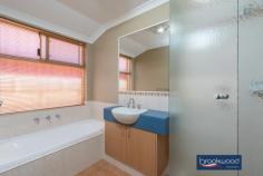 535 Horwood Rd Swan View WA 6056 $799,000 Options here with R12.5 zoning delivering the possibility to create a dual occupancy (STCA), subdivide now or later at the top of this elevated lot. Do it now or save it till later. Open the door to light filled living in this generously proportioned family home. Multiple living areas, easy – care landscaped gardens, and a large sheltered outdoor entertainment zone give a growing family flexibility. 4 bedrooms 2 bathrooms 2006 Summit brick & iron Open Plan central living Family-sized media room Separate activity room Main suite WI robe ensuite North-facing paved alfresco Easy-care landscaped gdns 1733 sqm with R12.5 zoning Close schools trail nat park Timber-look floors carry you along a wide central hallway past the spacious main suite, a separate media room, and on to a kitchen/meals/ family room arranged at the rear of the floorplan. Double doors connect this central living area to a separate activity room, while a sliding door to the large, north-facing alfresco entertaining creates seamless indoor-outdoor living. The galley-style kitchen features a long benchtop with an integrated breakfast bar, an electric oven, a 4-burner gas hob, and a dishwasher. Large windows fill this family hub with garden views and access to a paved outdoor living area surrounded by lawn, stone walls and a green screen of neatly clipped trees. An electric log fire at one corner of the open plan living space and ducted evaporative cooling throughout the home provide year-round comfort. The main suite sits at the front of the floor plan to offer a sense of privacy. Timber-look floors, timber blinds, and generous proportions create a calm and inviting parents’ retreat. A walk-in robe, split system air conditioner, and an ensuite with a separate WC bring comfort and convenience. A sense of space and pampering continues in the large media room, where plush carpet and ample room for a big screen and family-sized sofa set the stage for at-home movie nights. In the separate junior wing, three newly carpet bedrooms with built-in robes, a shared family bathroom with tub, shower, and vanity, and a separate WC give kids of all ages a space of their own. Family life can be hectic; this home is designed to make your days a little easier: a double garage with automatic entry, nearby schools, links to arterial roads, and easy access to walking and riding trails. And with the potential for subdivision or dual occupancy (STCA), multi-generational living or additional income could bring further benefits.