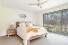 5 Sundew Close Gulmarrad NSW 2463 This stunning home is set on a large 4375m2 block, located in the ever-popular Gulmarrad area situated on the mid north coast of NSW. With a beautiful natural bush backdrop, privacy is assured with the nature reserve running along the back of the property. This is the perfect setting for this modern 4 bedroom home which is both accommodating and stylish, giving off great vibes whilst catering for the needs of a modern day family. A natural colour scheme throughout the home will compliment most furnishings and decor and the spacious design caters to the needs of a growing family, with an open plan living area that includes a contemporary kitchen, dining and family area with access to a large covered entertaining area via two large glass double sliding doors. An ideal place where you could no doubt spend a lot of time relaxing in the outdoor spa looking out onto nature and the dark skies and enjoy entertaining friends and family. Alternatively, after a long day you could just lay back in the comfort of your own media room and watch a good movie. Offering double doors to close off the space from the rest of the home, all you need is a big screen TV and some surround sound speakers and the mood is set for your own home theatre. Afterwards retreat to the huge master bedroom, featuring an attractive large ensuite with separate toilet plus a walk-in robe and sliding door access to the covered entertaining area, so you could sneak out for a late night spa without disturbing the rest of the household. Also located away from the main living areas are the other 3 bedrooms offering built-in-robes, ceiling fans and easy access to the main bathroom and laundry area. In addition to the double garage attached to the home there is a separate 4 bay colorbond shed with power, plus there is a gravel driveway to both. Another bonus is the Solar Hot Water System and 6kw Solar Power and established gardens and lawns.