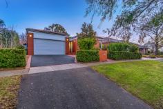 31 Frome St Griffith ACT 2603 In a private and discreet position on Frome Street, one of the Inner Souths quiet leafy avenues, a warm and comfortable home of generous proportions set well back and elevated behind a front of established gardens. The home offers a large formal entry to large sun filled lounge and dining areas with superb light, tiled floors, high ceilings with full length sliding doors and skylights which bathe the living areas with natural sunlight. Superb kitchen with outstanding design features, stone tops, quality appliances and great functionality with separate laundry. Dining area leads to two big bedrooms, two bathrooms and library area with rear entry. Expansive master suite with a double bedroom, two study desks with full height storage and luxury ensuite. Lovely garden spaces with open areas with private courtyard and double lock up garage. Superb Opportunity. – 3 Bedroom + Study, Ensuite and two Bathrooms – 217m2 internal – Formal entry with full height entry door and ceilings – Separate study with garage and external/internal access – Expansive master suite with double study desk, full height joinery – Fully tiled ensuite with double vanity, walk in shower and bath – Spacious family and dining areas, with fireplace, skylights and custom entertainment unit – Under tile heating and reverse cycle heating/cooling – Open kitchen with stone benchtops, quality appliances and concealed laundry – Two large double bedrooms to the rear with BIR robes and external access – Formal library with built in book shelf – Bathrooms to both bedrooms, one with separate bath – Double glazing throughout – Two water tanks – Fully landscaped with stone rockwalls and established trees – Two ponds with fountains – Double garage with high ceilings, electric roller door – North facing, plenty of natural sunlight – Walk to local schools and shops – Backing onto green space