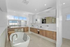 22 Ziggys Drive Thornlands QLD 4164 $1,790,000 The perfect merge of custom design and opulent finish this imposing double storey home will impress the most fastidious buyer. From the minute you enter the home through the large cedar pivot door to be greeted by the full-length void and stunning backlit timber feature wall and bridge you can't help but be impressed. Boasting a seamless flow between indoor and outdoor living this six bedroom home is ideal for families who love to entertain. * Custom built and designed family home featuring 2.7m ceilings throughout with a modern square set finish * Level 834m2 block with extensive landscaping including Bluetooth feature garden lights * Multiple open plan living spaces over both levels which include family room, meals area, parents retreat and theatre with tiered seating, large screen, and projector with built in surround sound roof speakers including speakers to the outside entertainment areas * Stunning chef's kitchen boasting 2 Pac finish cabinetry, stone benchtops with waterfall edge, Smeg appliances with 900 cooktop and glass splashback * Six bedrooms spread over both levels all featuring extensive wardrobe fit outs and two of the bedrooms boasting ensuite's * Four bathrooms laced with stone benchtops, custom joinery, and floor to ceiling tiles * Huge luxury master bedroom with a built-in dressing table, his/her walk in robes, ensuite with freestanding bath & shower with rain head and a large balcony looking out towards Moreton Bay * Private outdoor entertainment spaces leading out to the 8mx4m inground pool with bar and separate gazebo * Triple lock up garage with 2.4m high doors and drive through access plus a built-in storage area and gated side access for a boat or trailer * Reverse cycle air conditioning throughout plus a split system air conditioning unit in the garage * 20kw solar system with recently replaced Fronius Inverter * Security alarm system, data cabling throughout, audio/visual door camera upstairs and downstairs and ducted Vacuumaid