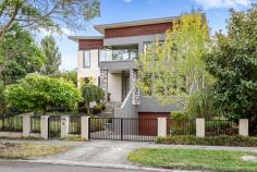 62 Essex Road Surrey Hills VIC 3127 $3,950,000 Enviably placed in one of Melbourne's most admired locales and directly opposite scenic South Surrey Park, this stately four bedroom, three bathroom residence plus study is created for entertaining. This modern family home presents a collection of light-bathed spaces displaying luxurious finishes, sophisticated colour palettes, plush carpets and lovely timber floors. An elegant living space overlooking the park merges to a central deck via bifold doors. A dining area enjoys two sets of bifold doors to the outdoor area, while a family/meals area with built-in-shelving and a smart fireplace looks over the sparkling in-ground pool and also has bi-folds to the sheltered alfresco dining which incorporates an outdoor fitted barbeque, sink and fridge. Adjoining the family/meals area is the sleek kitchen combining stone benchtops, stainless-steel appliances including a Miele dishwasher and abundant cabinetry with an extensive walk-in-pantry. A ground floor superbly-fitted study/home office appreciates the greenery of the parkland, while a powder room caters to residents and guests. Upstairs a second living area connects to a balcony and the sumptuous main bedroom, relishing park vistas, hosts a walk-in-robe and a dual-vanity ensuite. Three further bedrooms, two served by a separate walk-in-robe, share a twin-vanity bathroom, separate powder room and a further chic bathroom. A lower ground floor cinema room is perfect for viewing your favourite movie. Features include keyless entry, laundry, upstairs chute, drying room, ducted heating/refrigerated cooling, gas-log fireplace, valet vacuum, remote entry front gates, self-cleaning salt-water and solar heated pool, spa, elevated front balcony, sensor-lit gardens, solar panels, underground water tanks/pumps, five car garage with internal entry plus workshop with sink. A home to impress within close proximity to public transport, Canterbury Primary School, Camberwell High School, Canterbury Girls' Secondary College, various private schools, fabulous shops, supermarkets and Camberwell Fresh Food Market, Highfield and Wattle Parks, Aqualink Box Hill, Wattle Park Golf Course and renowned Maling Road shops and cafes.