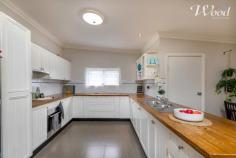 24 Day St Henty NSW 2658 $235,000 Tidy two bedroom home set on a huge 1012sqm block with rear lane access, and opportunity to develop further. The miner's cottage styled home features the traditional central hallway, Murray pine timber flooring, which opens up to a large open kitchen meals & family room. This also extends to a covered outdoor alfresco, entertainment space to enjoy that large block. The kitchen has been tastefully updated and includes an enormous amount of preparation benches, cupboards, an electric cooktop and under bench oven. The open planned living room offers a wood fire and a reverse cycle split system air conditioner. The 2 generous sized bedrooms are service by a bathroom and then there is a separate laundry & toilet. With front and rear access, the property includes a double carport and as mentioned, a block plenty large enough for a second dwelling, or any amount of shedding if required. Centrally located within the township, you can walk down the road and have a swim at the local pool, there's plenty of shopping facilities and I hardly miss the opportunity to call in to the local bakery for a coffee & where you can enjoy some beautiful treats or a wonderful lunch.