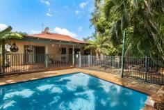 11 Bowerbird Loop Djugun WA 6725 $599,000 Positioned just five minutes' drive from both China Town & Cable Beach, and within easy walking proximity to Roebuck Primary School and beautiful Cygnet Park, this incredibly spacious three-bedroom home ticks a lot of boxes. A long concrete driveway with additional parking to the side, manicured front landscaping and a single covered carport are excellent introductions to the home and promote a welcoming street appeal. With two wrap-around verandas and extended eaves protecting the home from heat, respite is also offered in the form of a resort-style swimming pool in the backyard. Ceiling fans and split-system air conditioning also promote comfort throughout the abode. An open-plan design showcases the enormous living room, modern down lights and ceramic floor tiles. Large sliding windows invite natural light and cool evening breezes, with timber Venetian blinds ensuring privacy. Two 1200mm wide sliding glass doors are protected by security screens and lead out to a covered entertaining area which looks out across an in-ground swimming pool which is framed by lush palms and rock gardens. The entertainer's kitchen is characterised by a large L-shaped breakfast island boasting light-oak cabinetry and a contemporary 40mm speckled black stone counter top. Storage is abundant, and the main benches are framed by a sky-blue glass splashback. Avid home chefs will adore the 600mm integrated cooking appliances that are adorned by a partially-concealed gourmet rangehood. Three well-sized bedrooms enjoy ample built-in storage with the main bedroom showing off a sizeable walk-in robe and private ensuite. Both bathrooms in the home are well-appointed with contrasting ornate wall and floor tiles, opaque glass screens, generous vanity units and a tiled hob bathtub to the main for the kids. Adding to the convenience of the locale, a short drive will take you to the centre of Broome and all the popular amenities, such as shops, dining and cafe precincts.